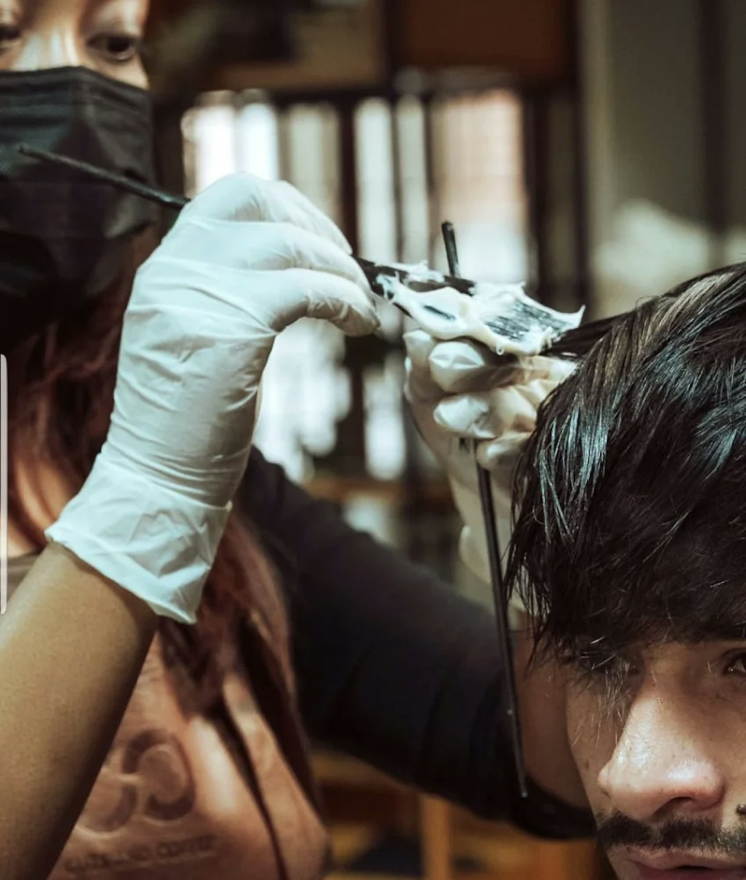 Barber coloring hair of a customer