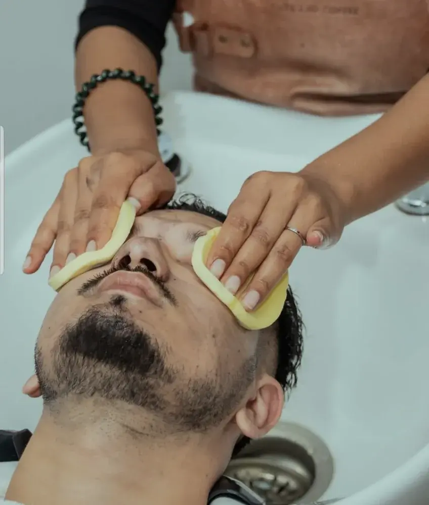 Barber performing a cleansing on a customer