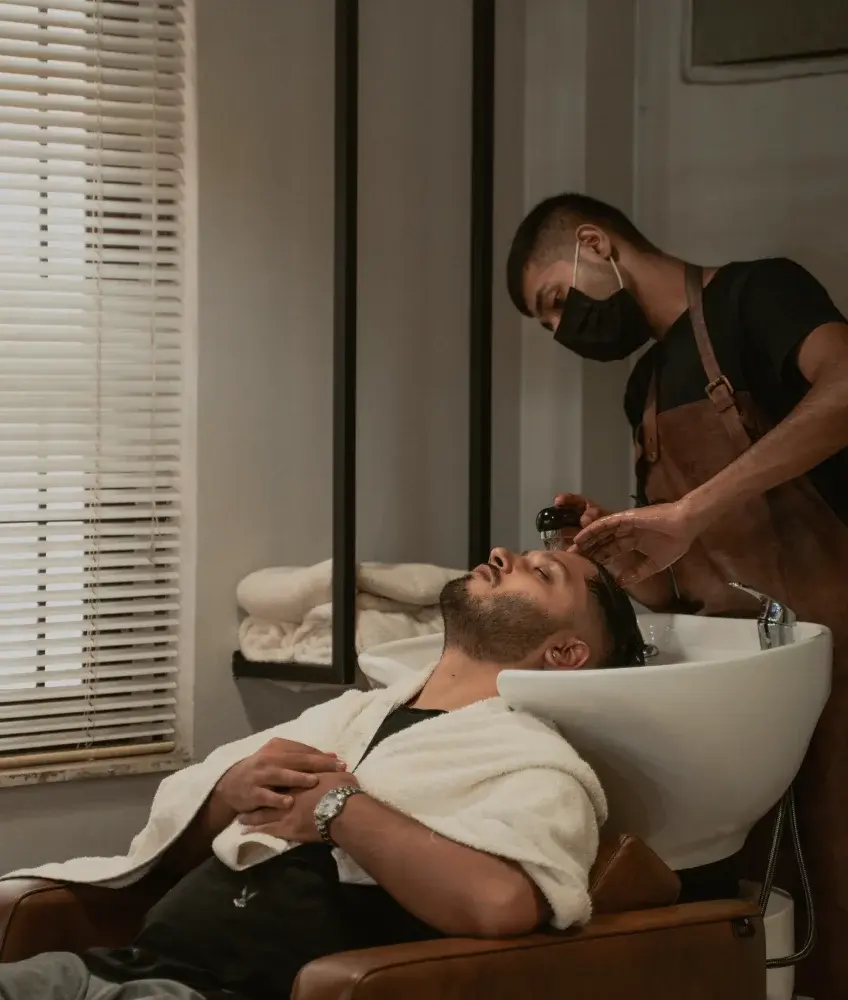 Barber washing hair of a customer